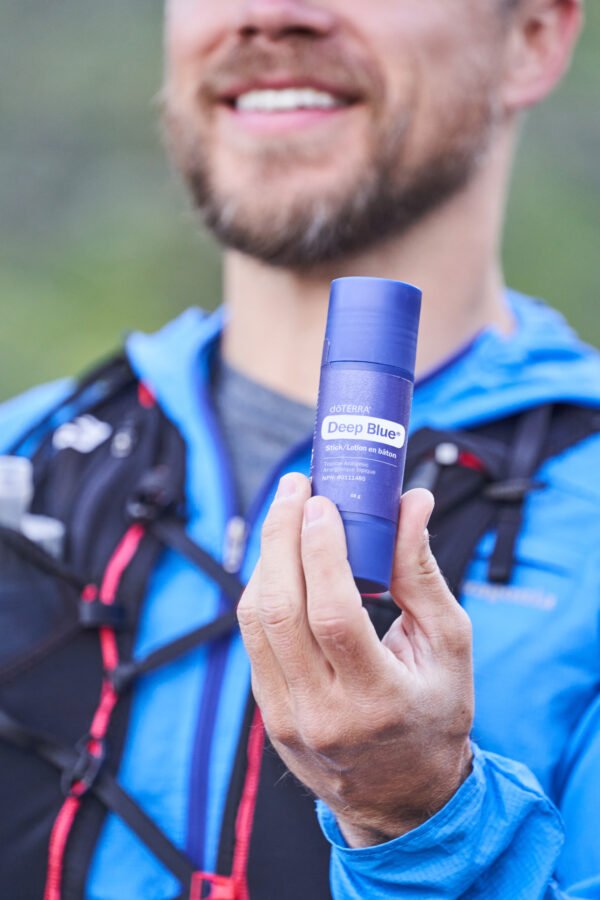 Man hiker holding doTERRA Deep Blue Stick