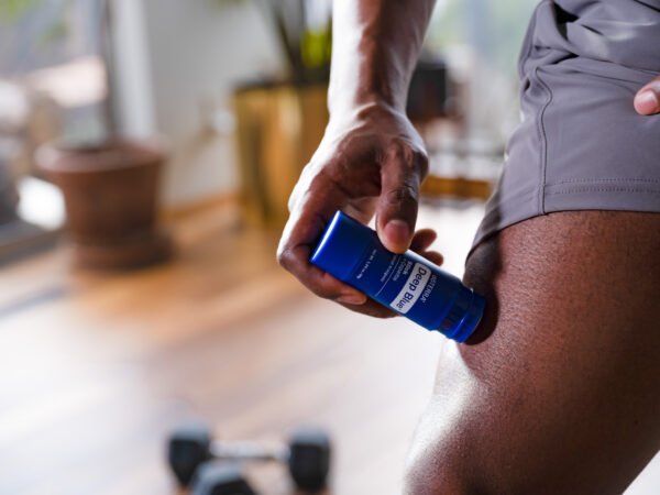 Man applying doTERRA deep blue on leg