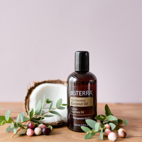 doTERRA Fractionated Coconut Oil with open coconut and decoration fruits